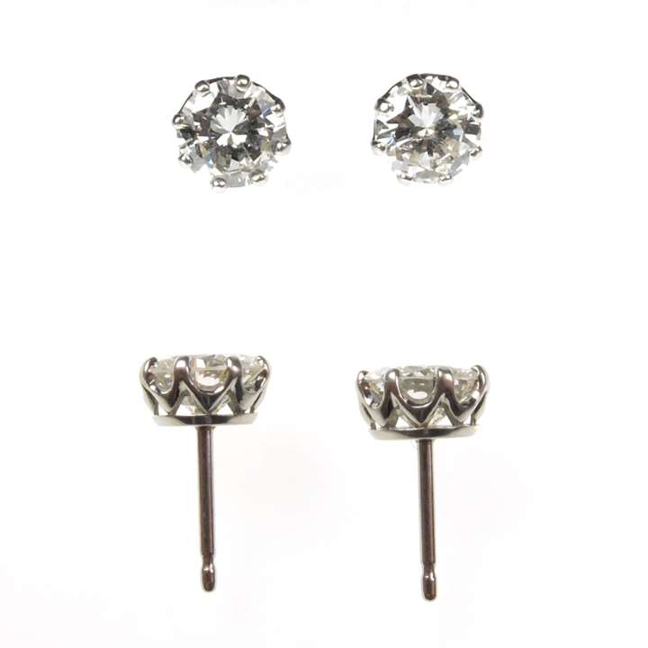 Pair of diamond stud earrings, 1.24cts and 1.22cts, claw set in coronet mounts